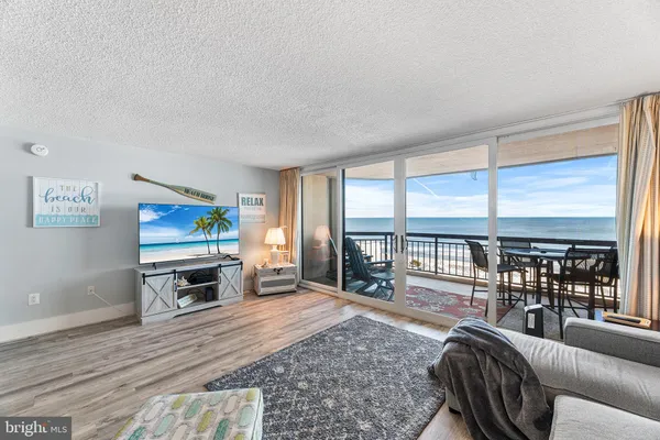 a living room with furniture large window and flat screen tv