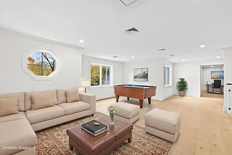 a living room with furniture a rug and a window
