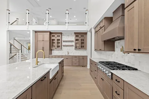 a kitchen with stainless steel appliances granite countertop a stove and a sink