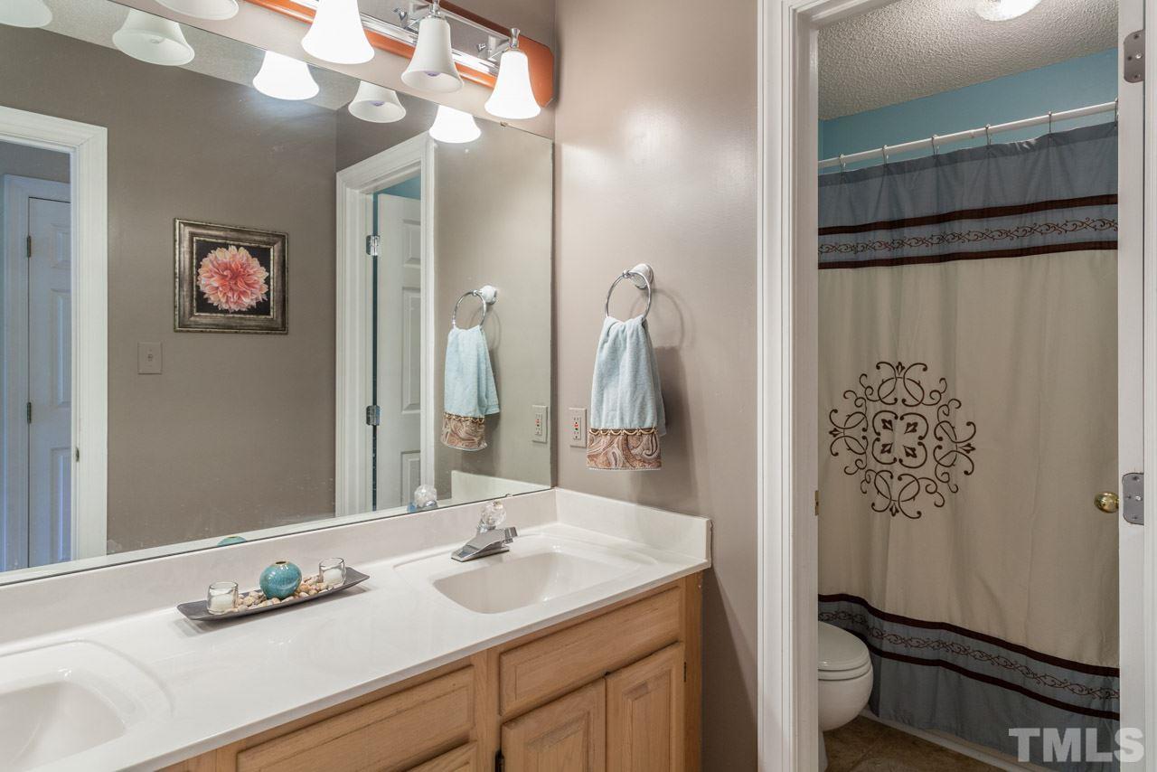 10001 Goodview Court Raleigh, NC 27613 - Photo 14 of 25 Full bath upstairs with beautiful tile flooring, separate double vanity area