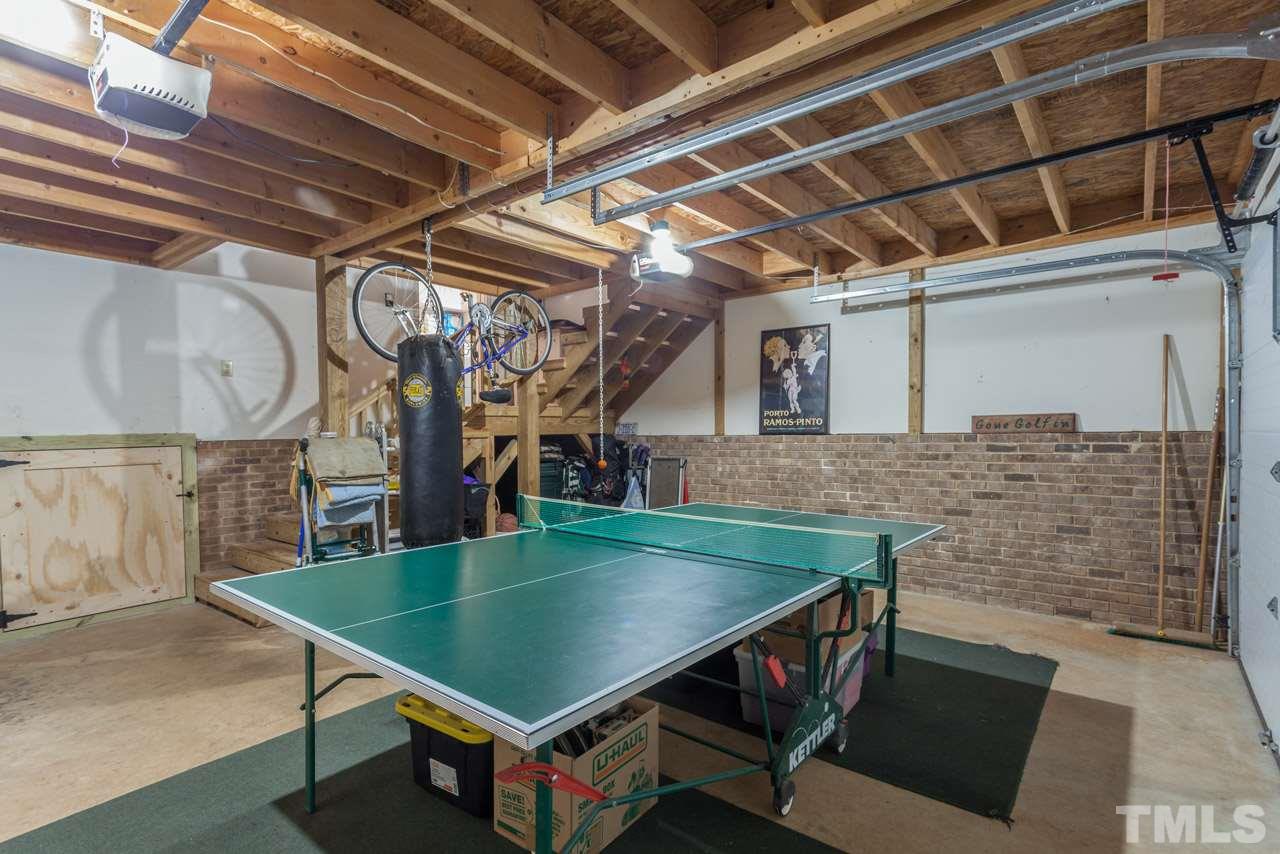 10001 Goodview Court Raleigh, NC 27613 - Photo 20 of 25 Garage with huge walk-up storage loft above and door leading out to large workshop/walk-in crawlspace