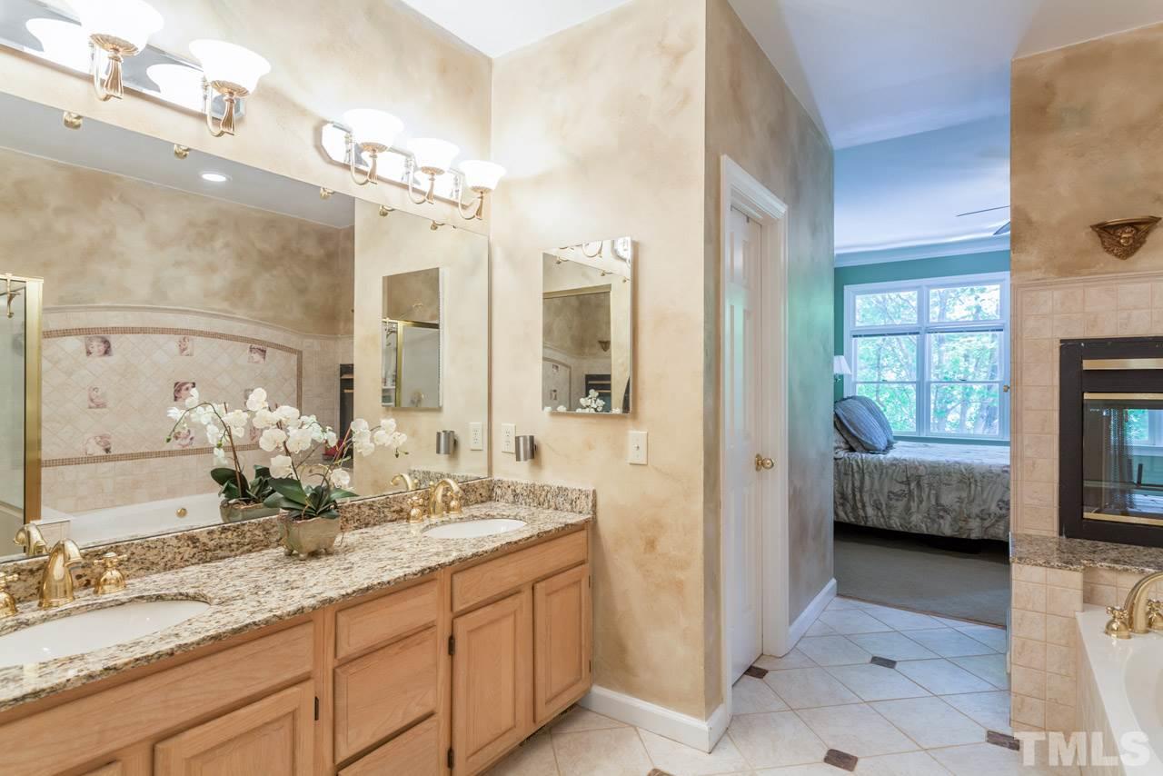 10001 Goodview Court Raleigh, NC 27613 - Photo 4 of 25 Large master bath complete with fireplace, tile, double vanity with granite, and large whirlpool tub with separate shower
