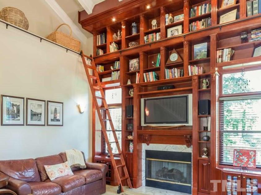 10001 Goodview Court Raleigh, NC 27613 - Photo 8 of 25 Stunning 2 story custom built library wall with ladder is a beautiful unique feature