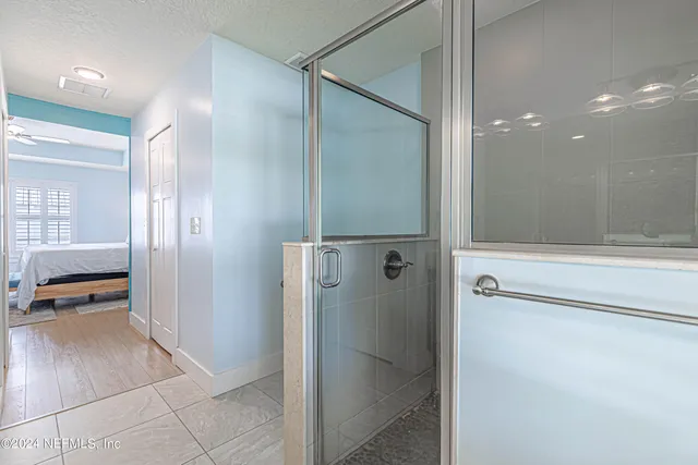 a bathroom with a granite countertop sink a toilet and a large mirror