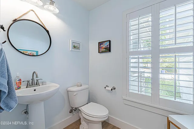 a view of a patio with couches chairs and wooden floor