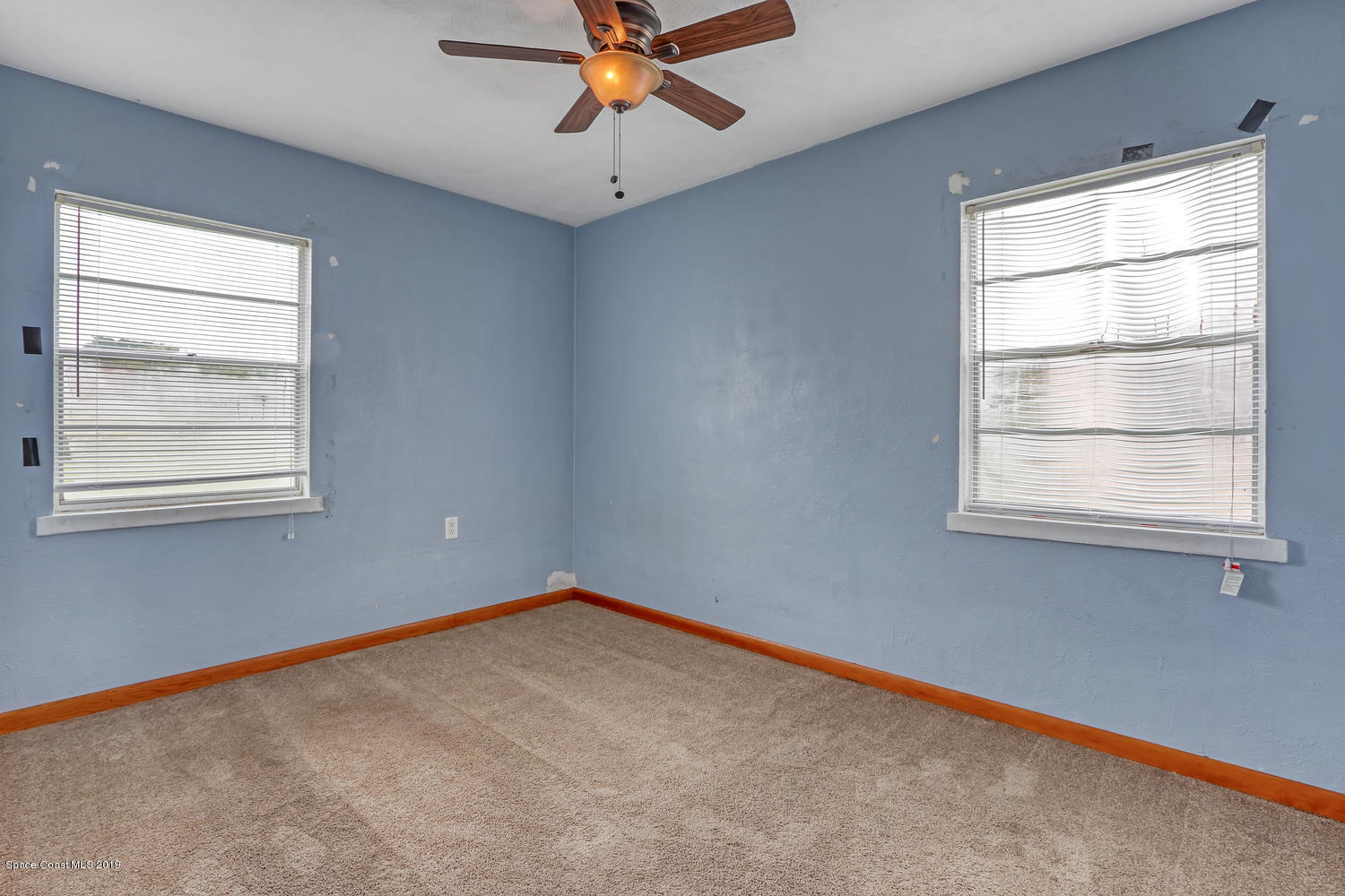 1003 Pinedale Road Rockledge, FL 32955 - Photo 11 of 19 an empty room with a window and a fan