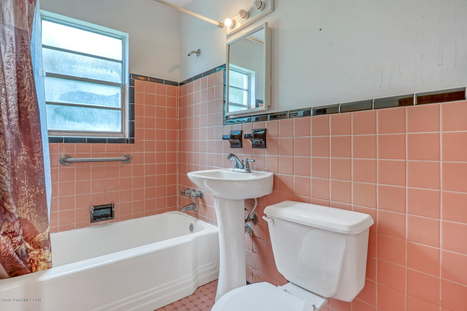 1003 Pinedale Road Rockledge, FL 32955 - Photo 12 of 19 a bathroom with a sink a toilet and bathtub