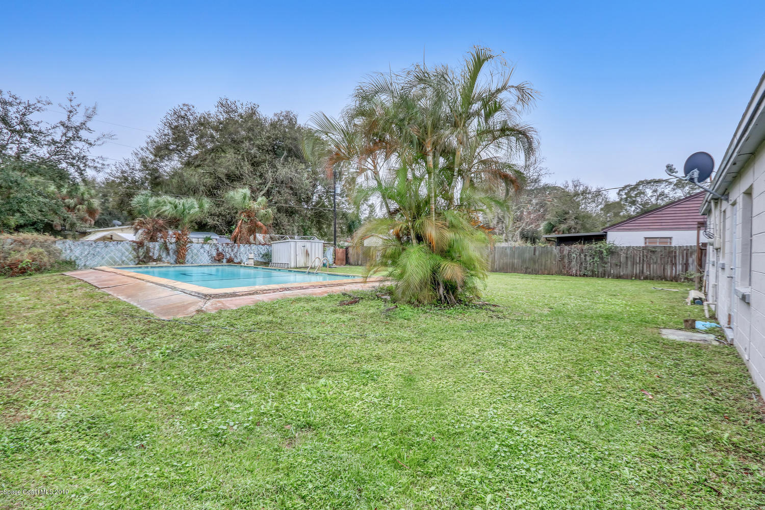 1003 Pinedale Road Rockledge, FL 32955 - Photo 16 of 19 a view of backyard of house with green space