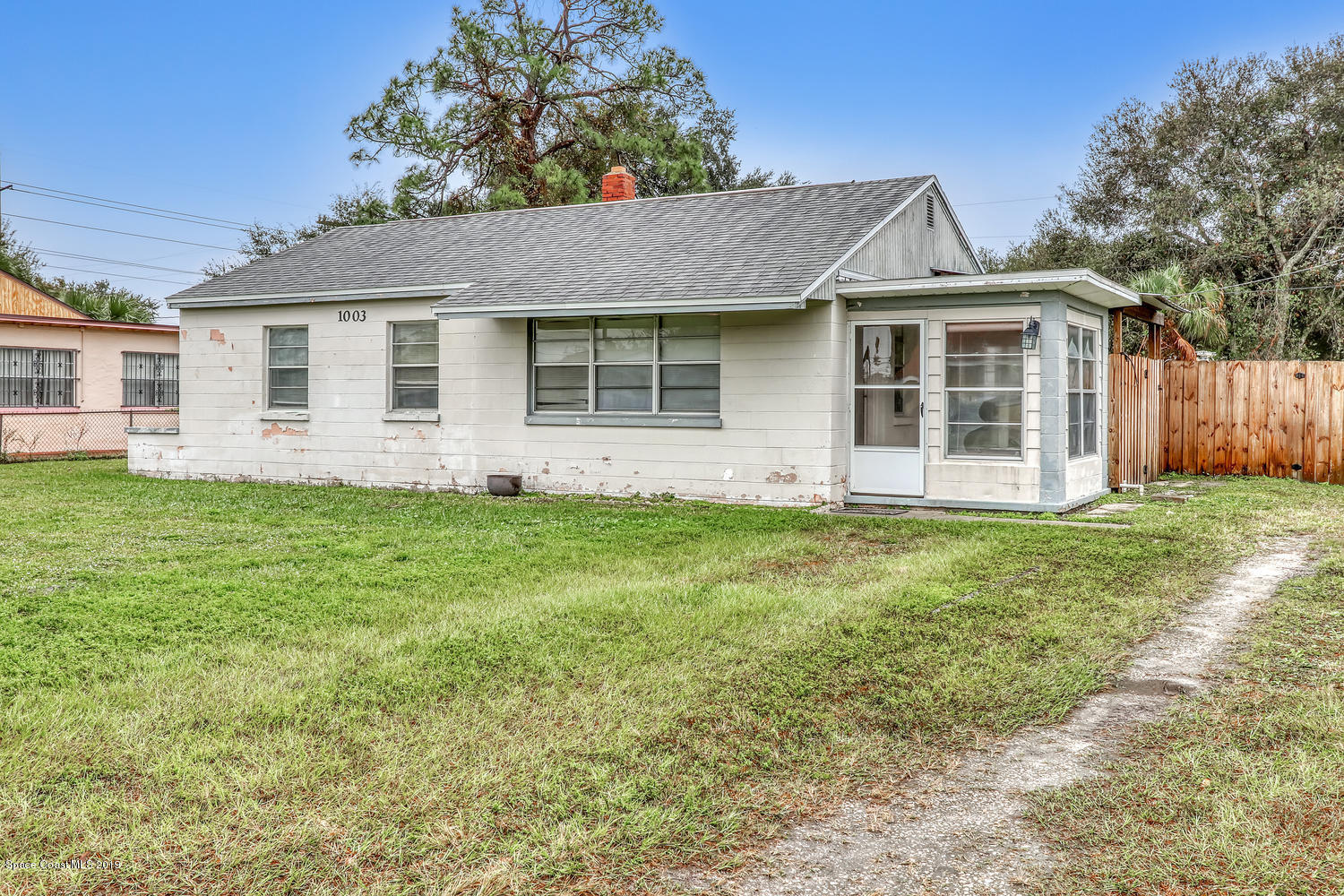 1003 Pinedale Road Rockledge, FL 32955 - Photo 4 of 19 a front view of a house with a garden