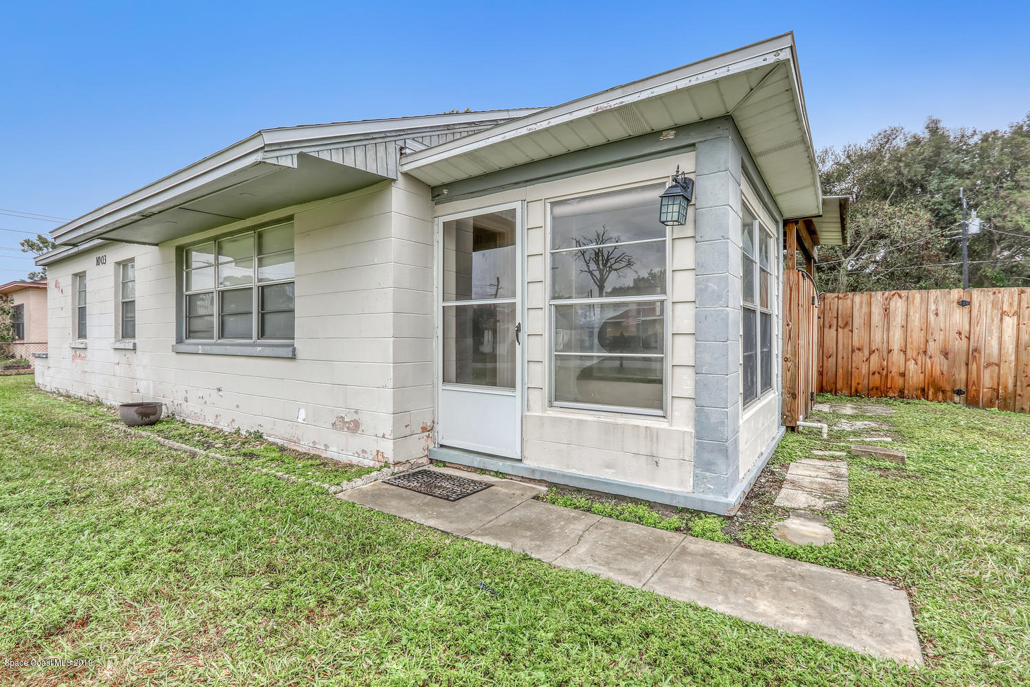 1003 Pinedale Road Rockledge, FL 32955 - Photo 5 of 19 a front view of a house with a yard