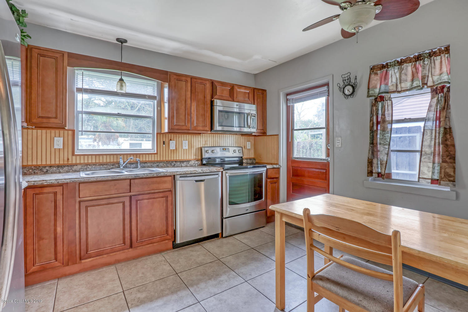 1003 Pinedale Road Rockledge, FL 32955 - Photo 8 of 19 a kitchen with a stove a sink and a microwave