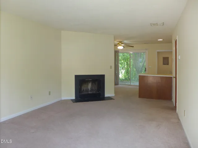 a view of an empty room with a fireplace