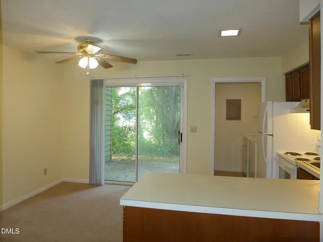 a room with wooden floor and a ceiling fan