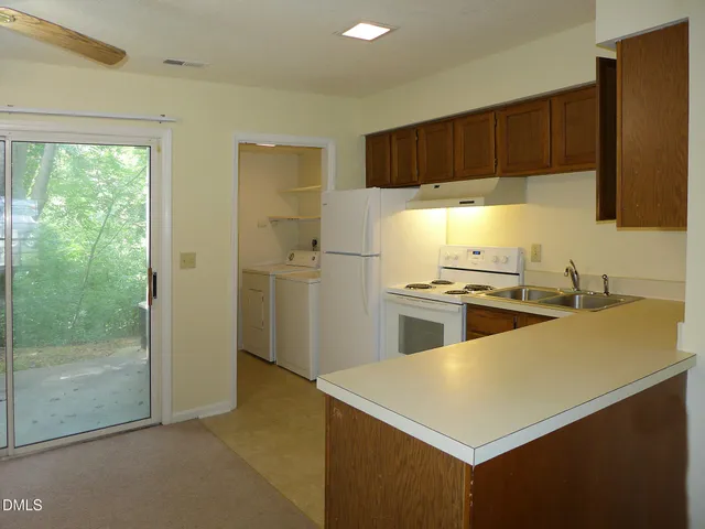 a kitchen with a refrigerator and a sink