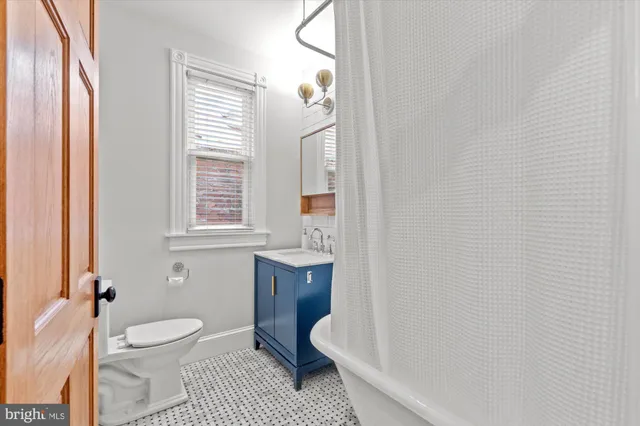 a bathroom with a toilet a sink and bathtub