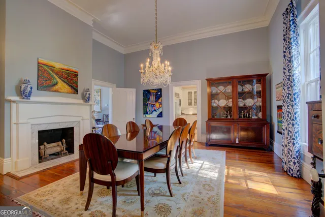 a kitchen with a stove a sink a window and wooden floor