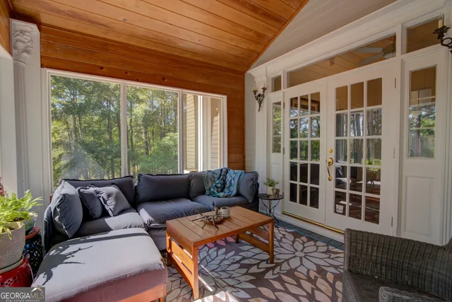 a living room with furniture pool table and a flat screen tv