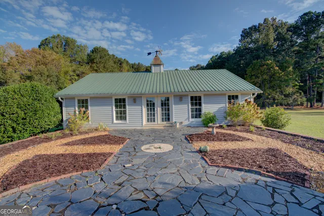 an aerial view of green landscape with trees houses and mountain view