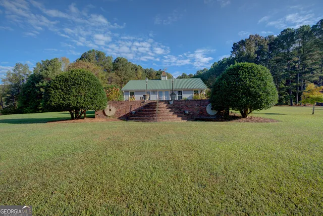 an aerial view of a house with outdoor space