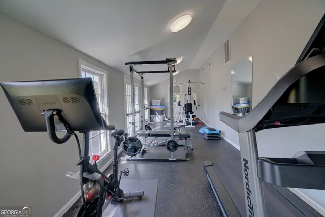 an aerial view of a house with a yard and lake view