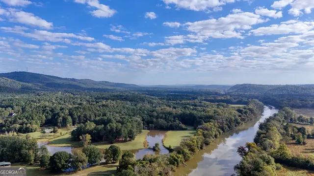 a view of a porch with furniture and a yard