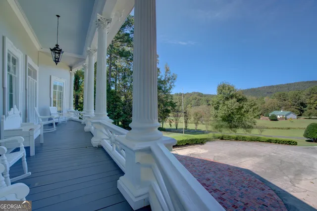 a living room with furniture wooden floor and a dining table
