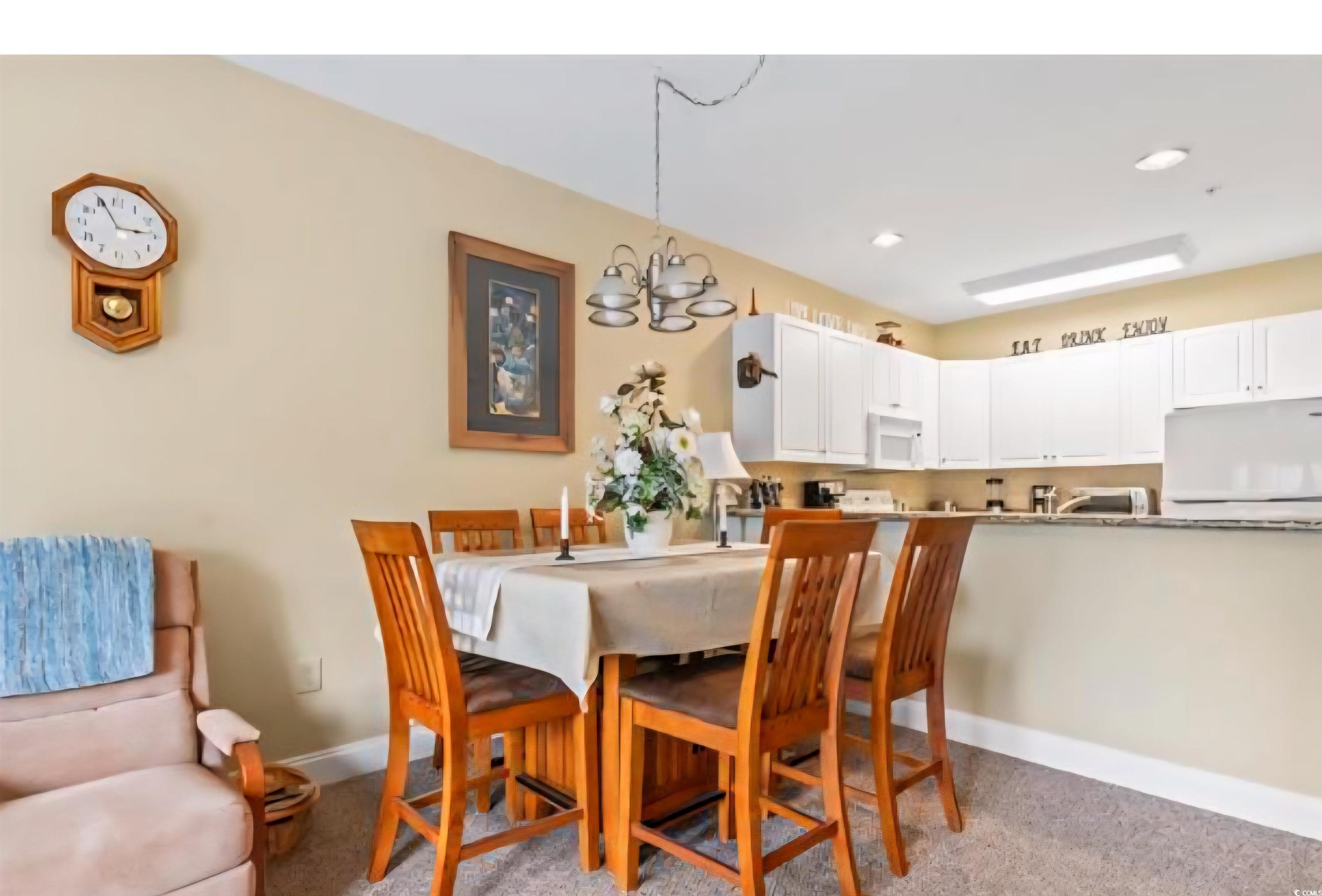 1009 World Tour Boulevard Myrtle Beach, SC 29579 - Photo 10 of 36 Dining room featuring a chandelier, recessed lighting, and light carpet