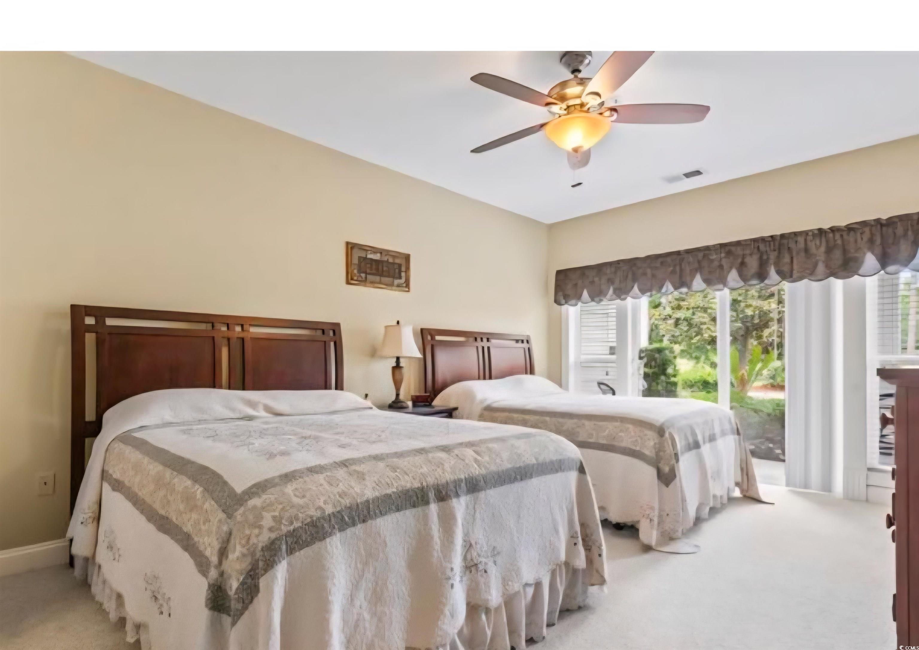 1009 World Tour Boulevard Myrtle Beach, SC 29579 - Photo 14 of 36 Bedroom featuring light colored carpet, access to exterior, and ceiling fan