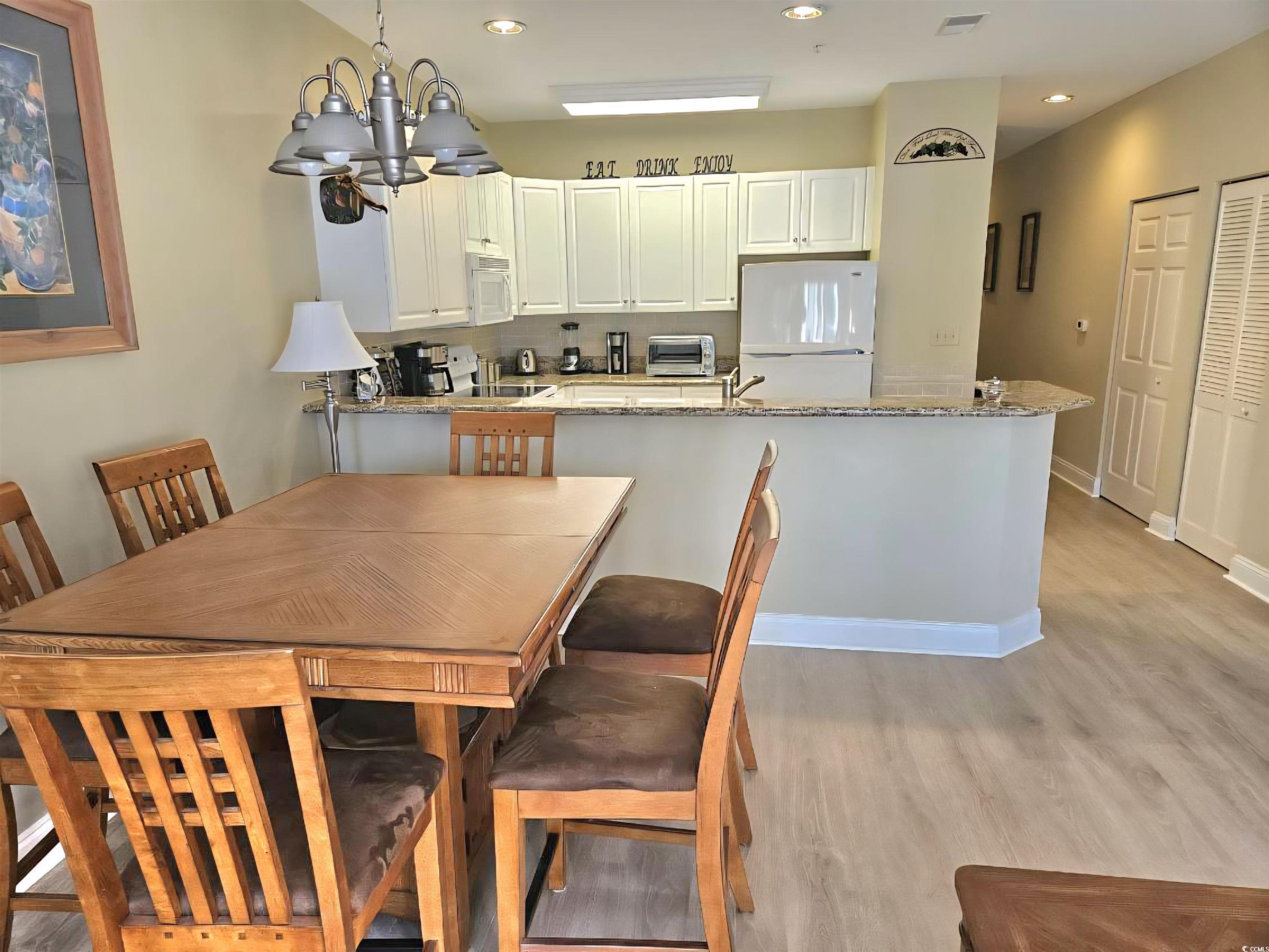 1009 World Tour Boulevard Myrtle Beach, SC 29579 - Photo 2 of 36 new floors , Dining room with a chandelier, light wood-type flooring, and recessed lighting