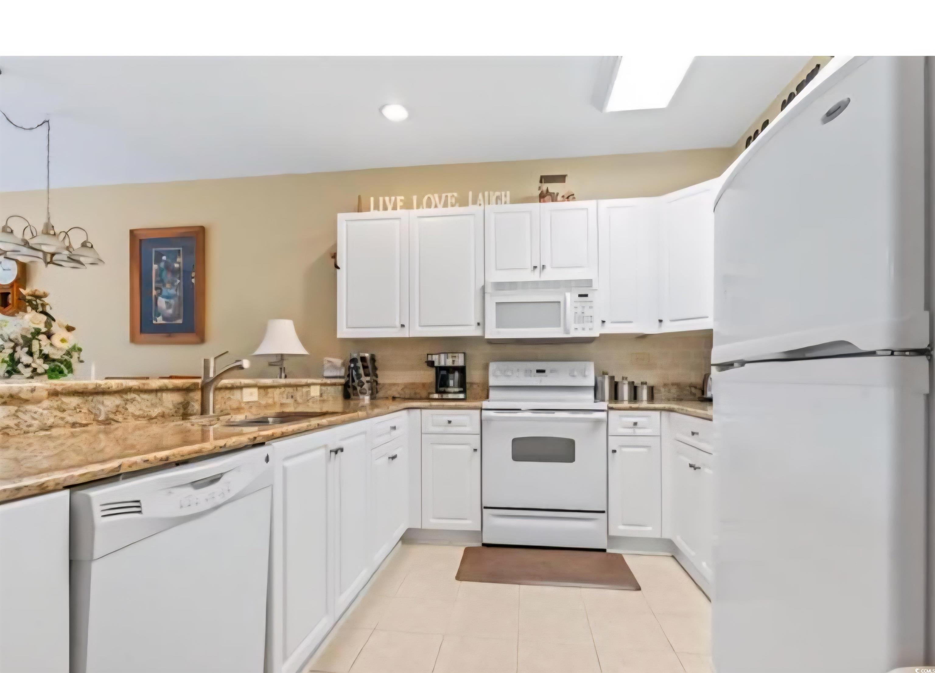 1009 World Tour Boulevard Myrtle Beach, SC 29579 - Photo 22 of 36 Kitchen featuring white appliances, white cabinets, light tile patterned floors, and recessed lighting