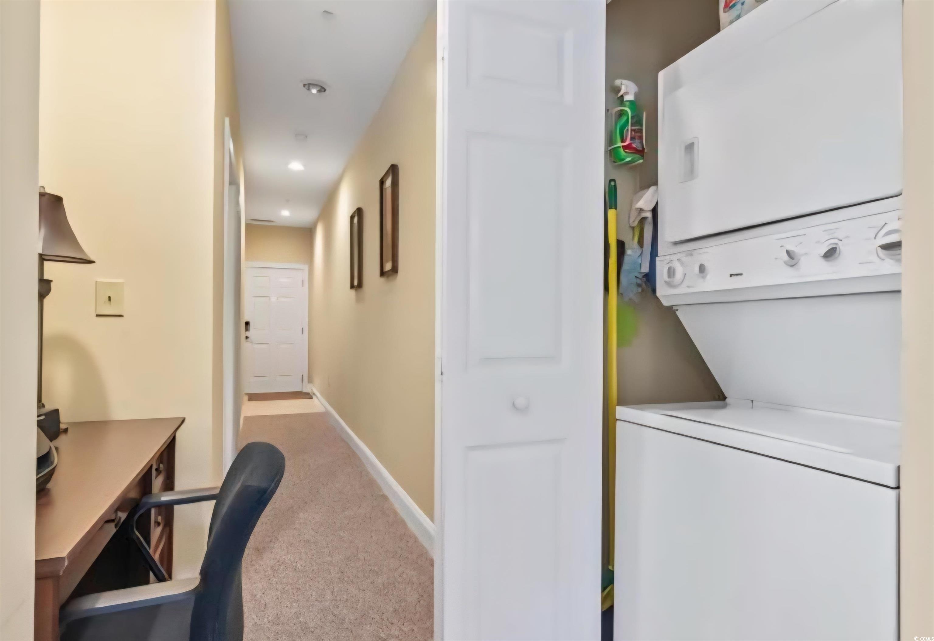 1009 World Tour Boulevard Myrtle Beach, SC 29579 - Photo 33 of 36 Laundry area with light colored carpet, stacked washing machine and dryer, a desk, and recessed lighting
