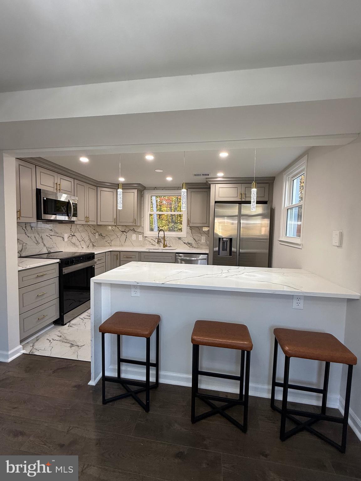 13014 Kerrydale Road Woodbridge, VA 22193 - Photo 25 of 53 a kitchen with a table chairs sink and cabinets