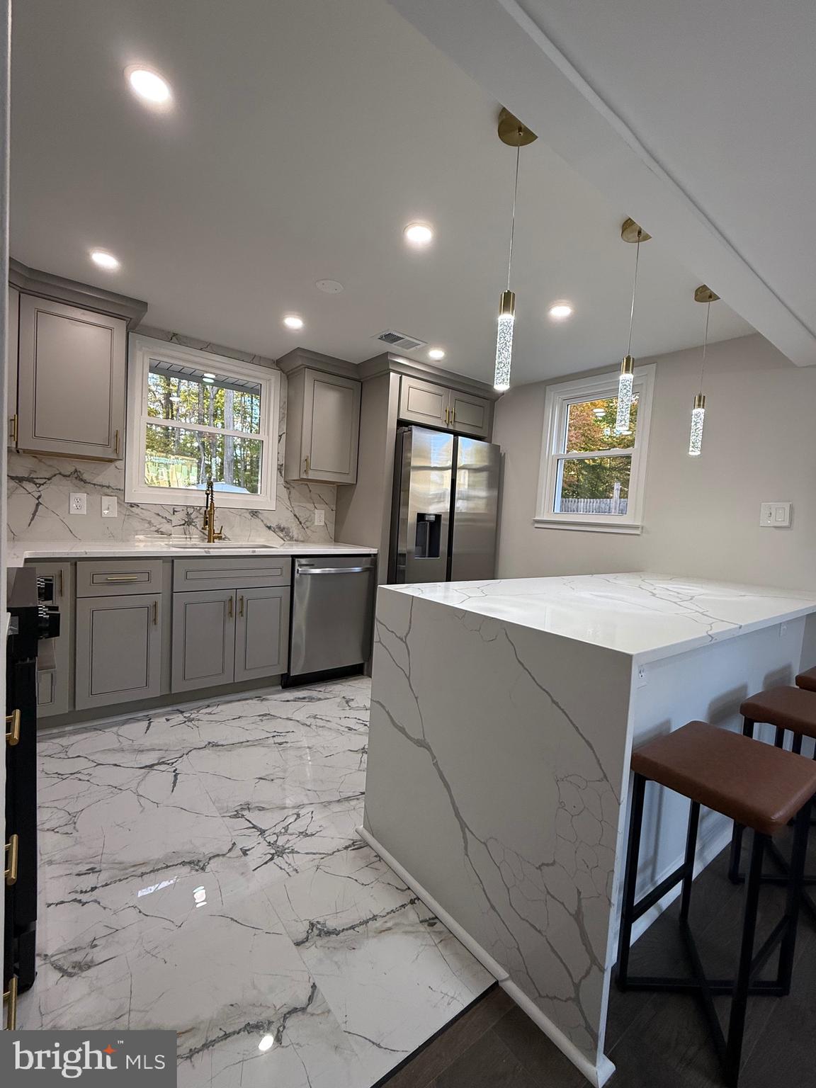 13014 Kerrydale Road Woodbridge, VA 22193 - Photo 25 of 52 a large kitchen with kitchen island a sink table and chairs