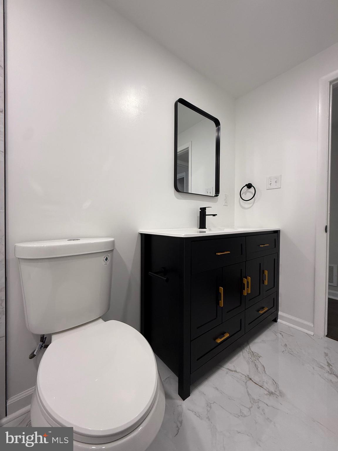 13014 Kerrydale Road Woodbridge, VA 22193 - Photo 29 of 52 a bathroom with a toilet a sink and mirror