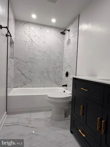 a bathroom with a toilet and a bathtub
