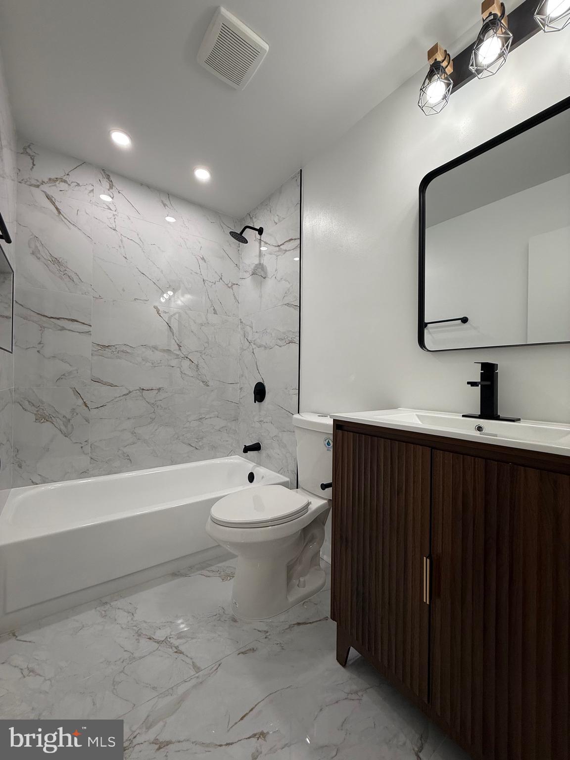 13014 Kerrydale Road Woodbridge, VA 22193 - Photo 34 of 53 a bathroom with a toilet a sink a mirror a bathtub and vanity