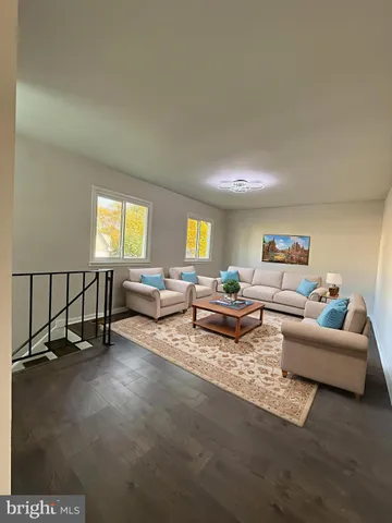 an empty room with windows and hardwood floor