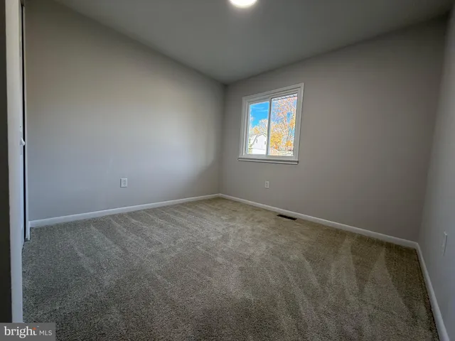 a bedroom with bed and a potted plant