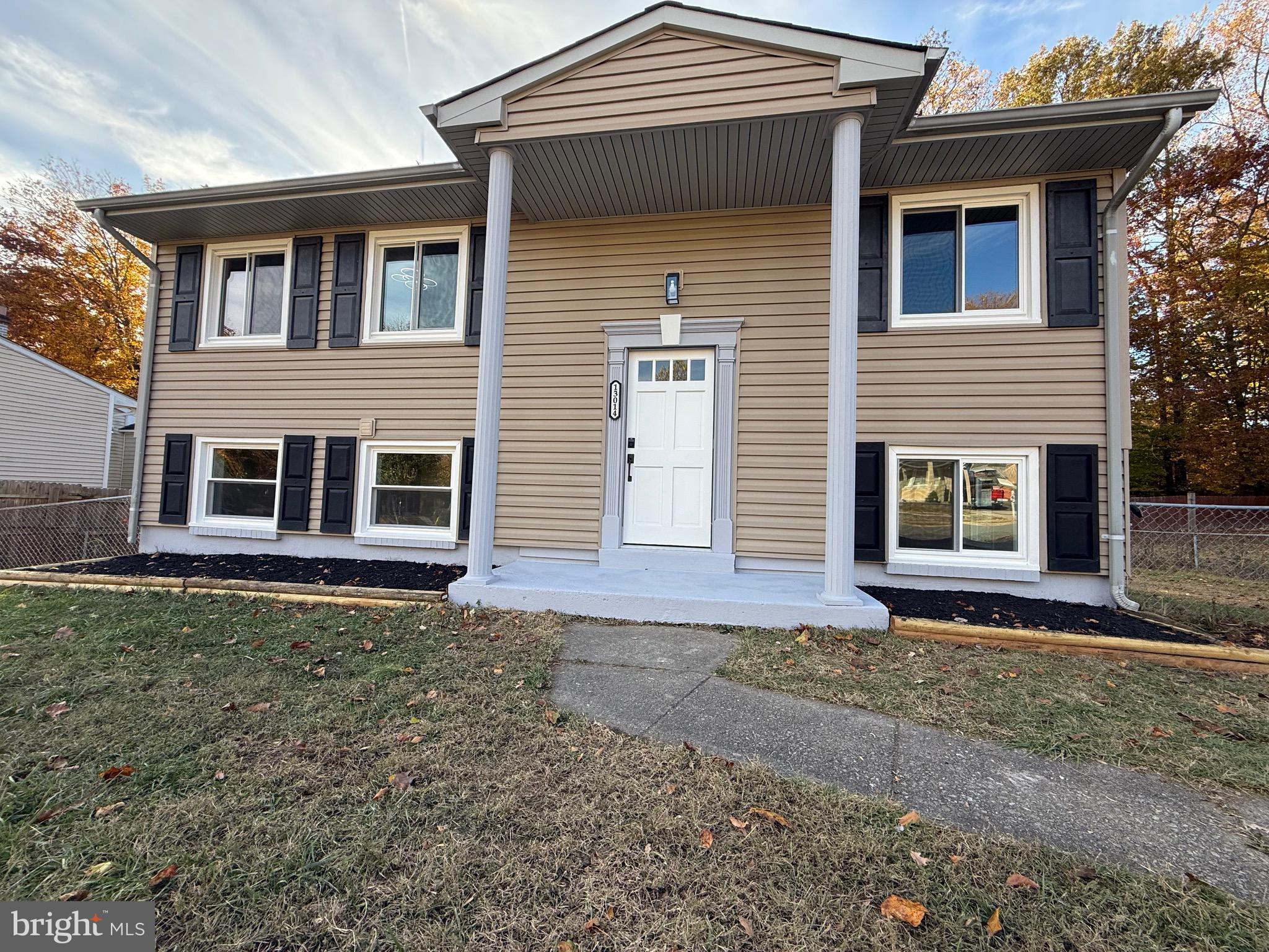 13014 Kerrydale Road Woodbridge, VA 22193 - Photo 5 of 53 a front view of a house with a yard