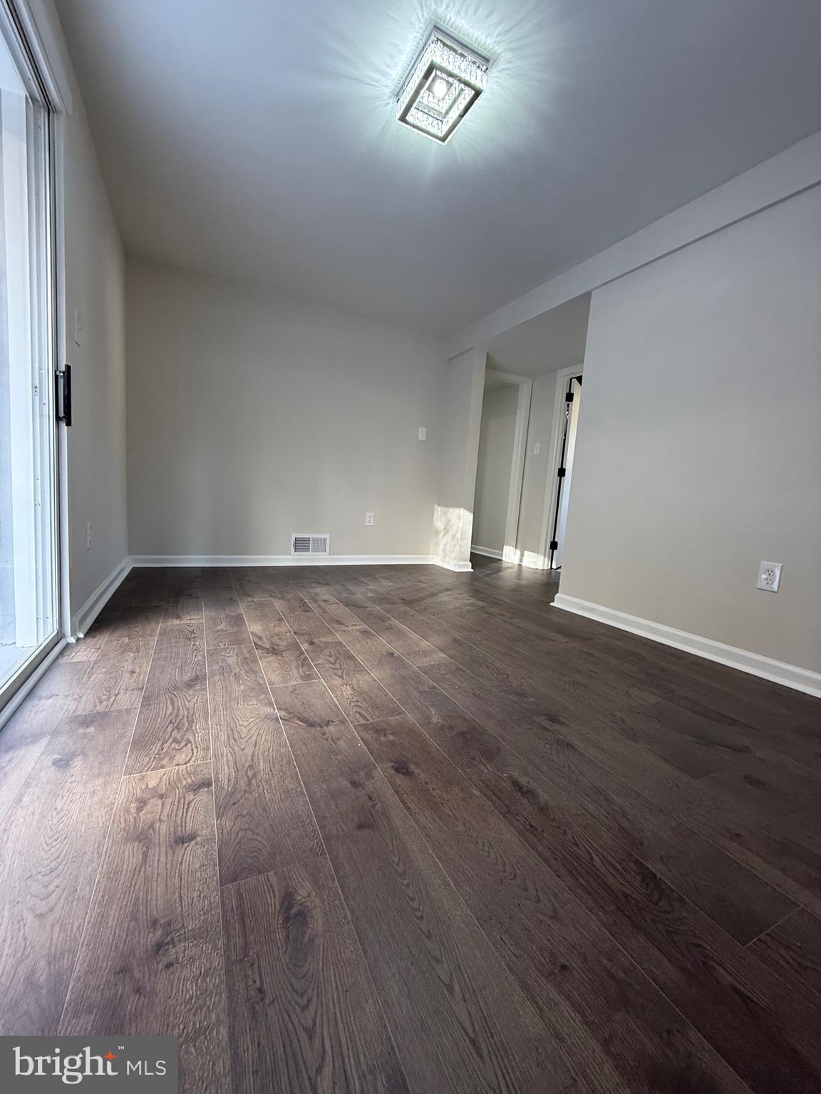 13014 Kerrydale Road Woodbridge, VA 22193 - Photo 52 of 53 a view of an empty room with wooden floor and a window