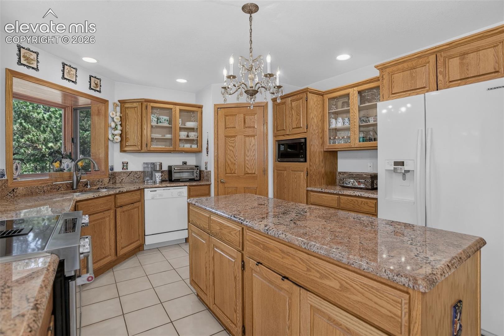 11570 Milford Road Elbert, CO 80106 - Photo 18 of 49 Kitchen with 6' island and box window over sink.