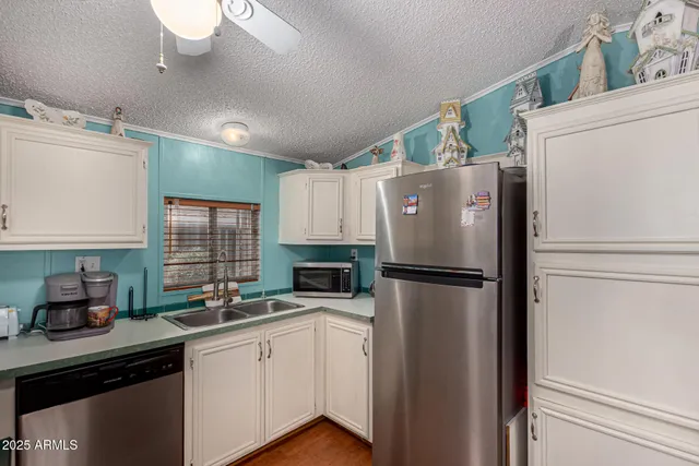 a white refrigerator freezer sitting in a kitchen