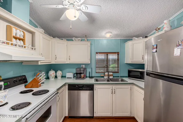 a kitchen with a refrigerator a stove a microwave and cabinets