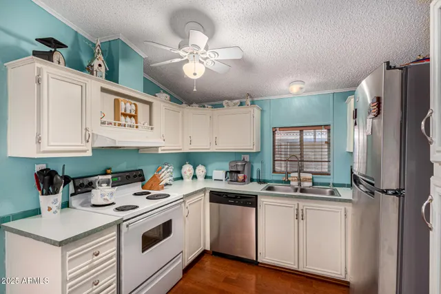 a kitchen with a sink a refrigerator a stove and cabinets