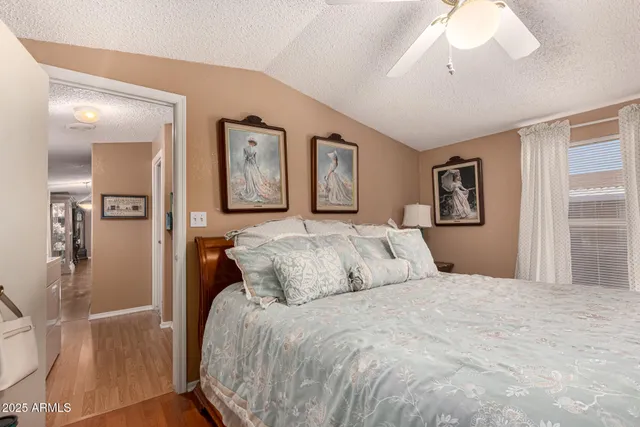 a bedroom with a large bed and a chandelier