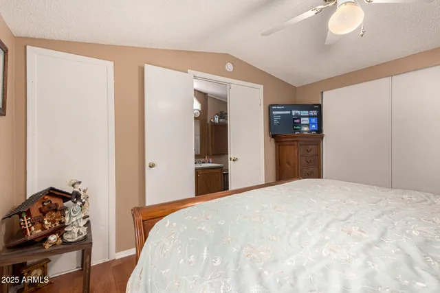 a bedroom with a bed and a dresser in it