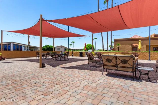 a swimming pool with outdoor seating and yard