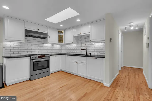 a kitchen with stainless steel appliances granite countertop a sink and cabinets