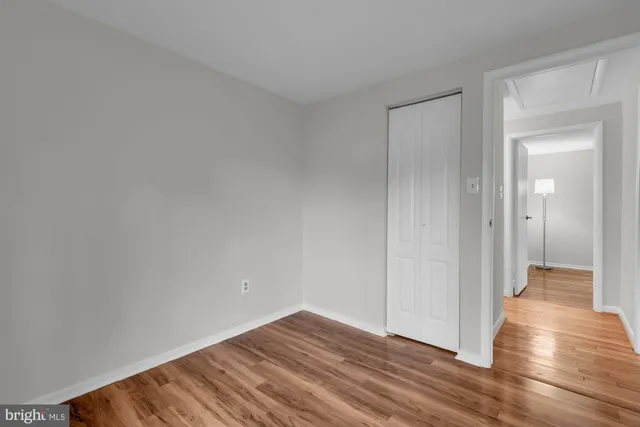 a view of hallway with wooden floor