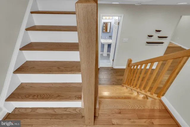 a view of staircase with white walls and railing